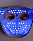 Blue LED face mask with a gray background